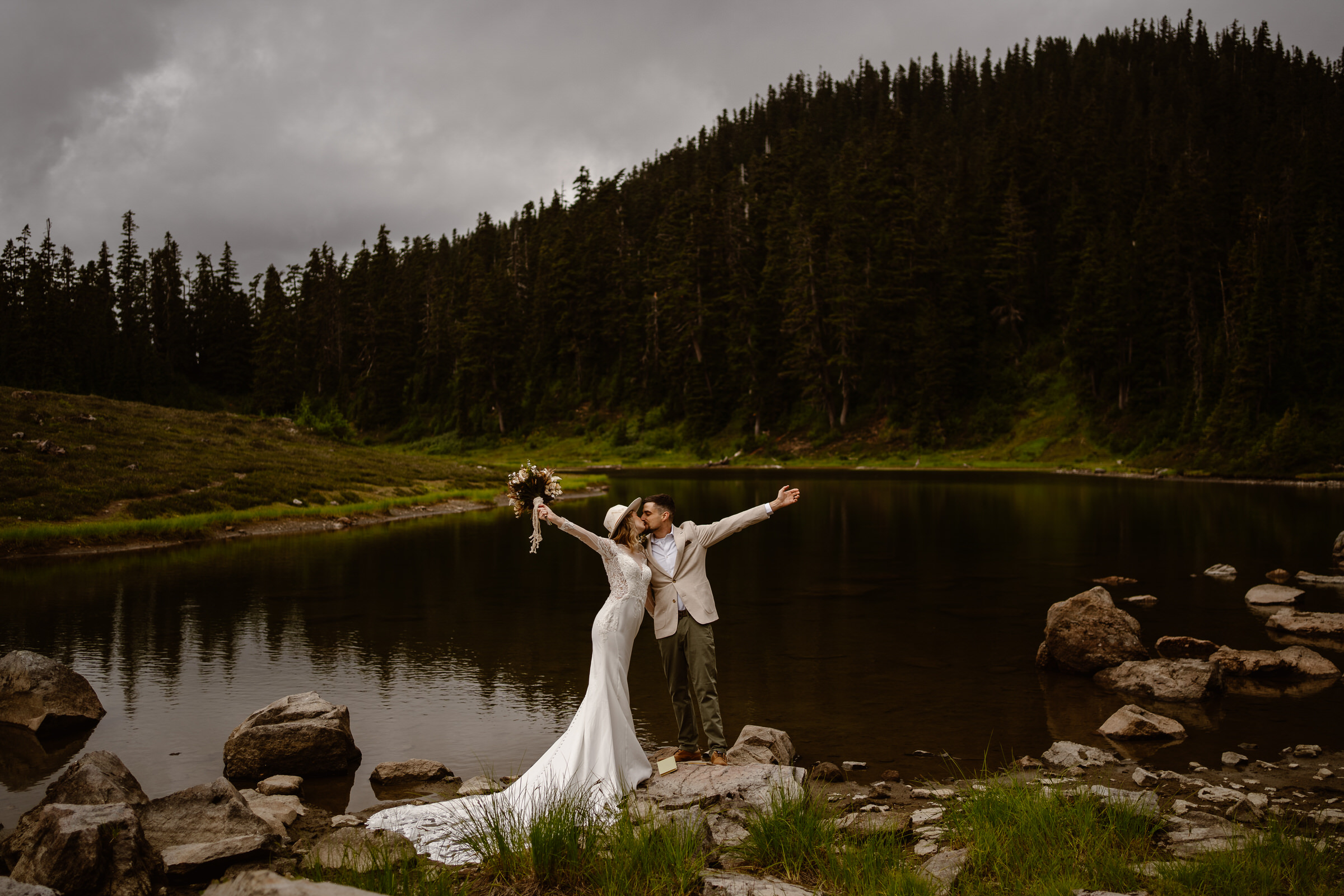 a bride and groom celebrate their vow exchange at an alpine lake during their north cascades elopement