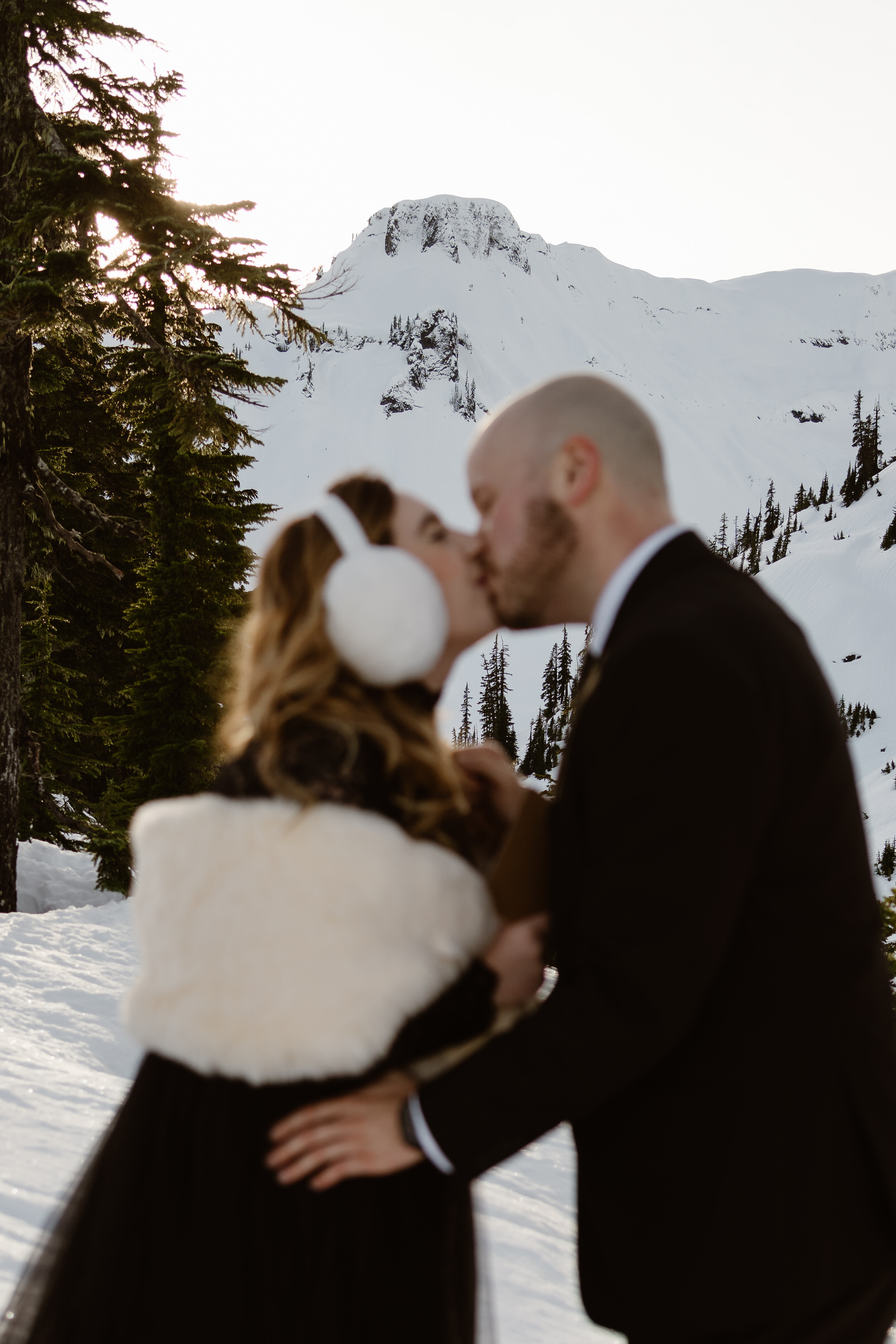 a bride and groom kiss during their North Cascades snowshoeing elopement
