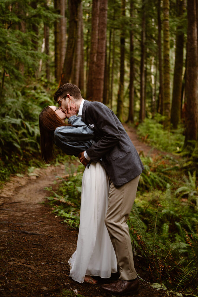 a bride and groom kiss during their elopement in the olympic national forest