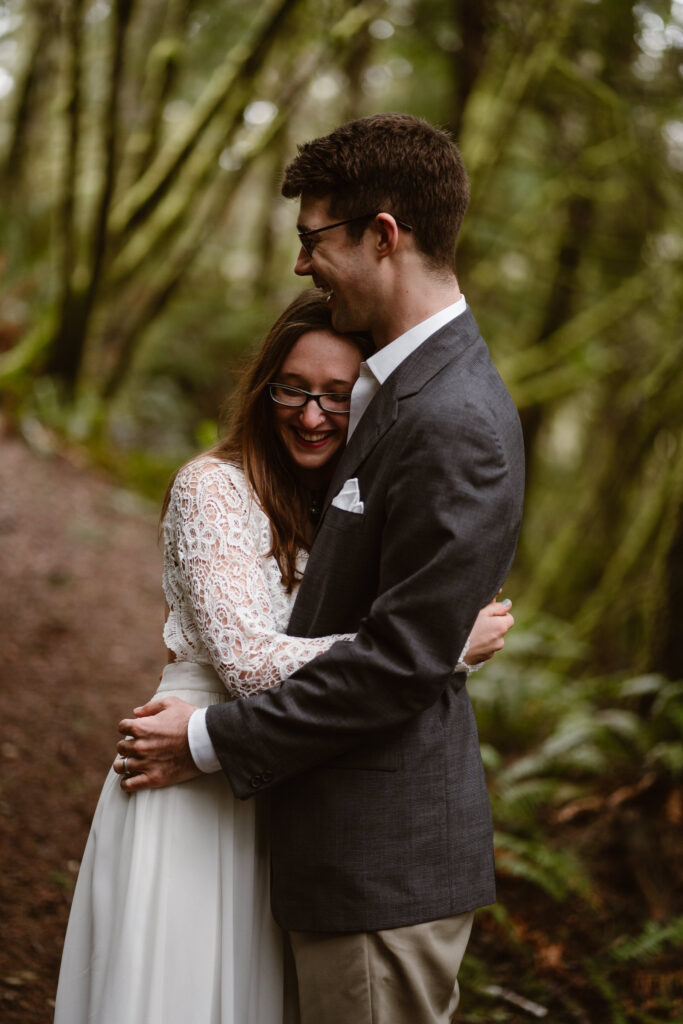 a bride leans into a groom's chest during their olympic peninsula elopement