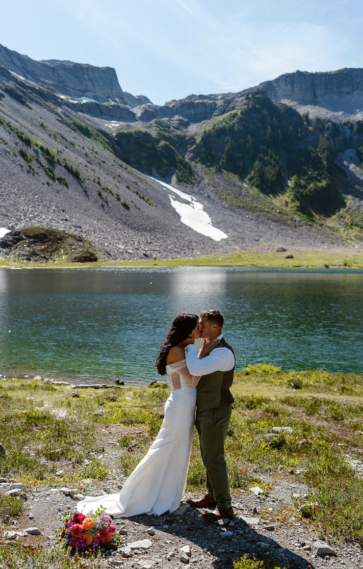 a bride and groom share a first kiss and dance to celebrate during their north cascades elopement