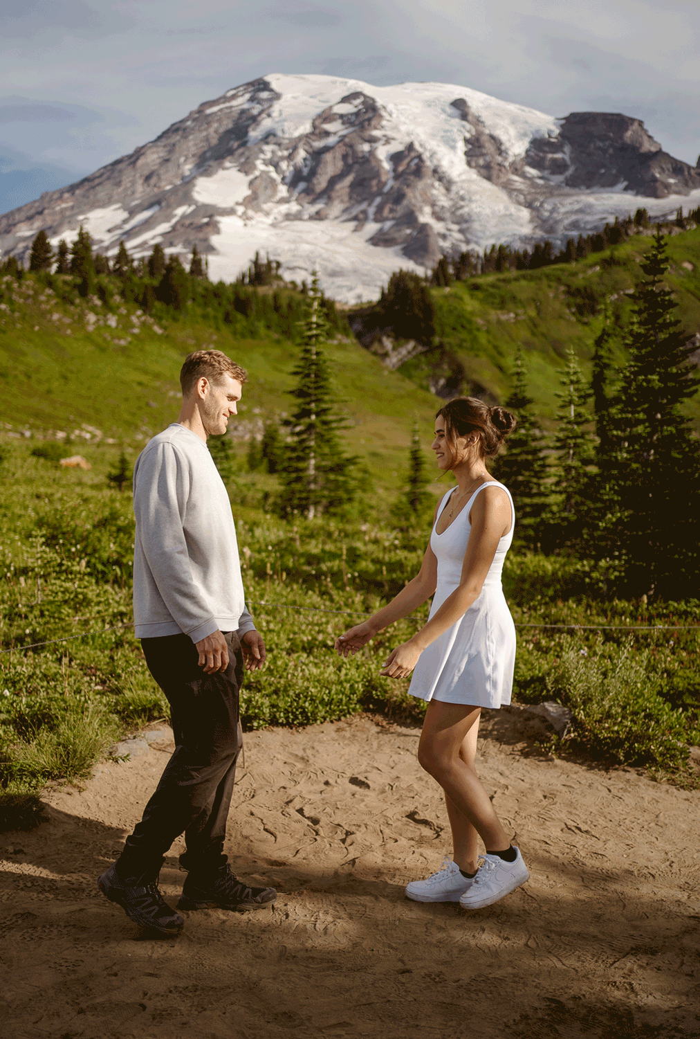 GIF of a couple stepping towards each other and kissing while the bride pops her foot before their mt rainier micro wedding