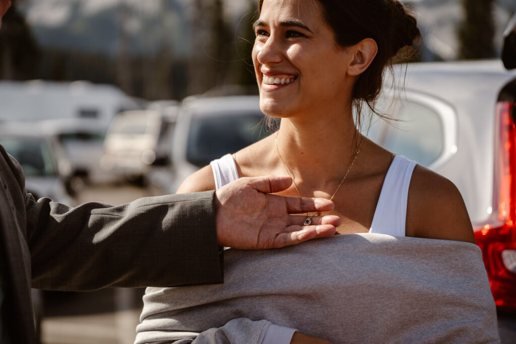 a bride's father examines her necklace during a mt rainier micro wedding