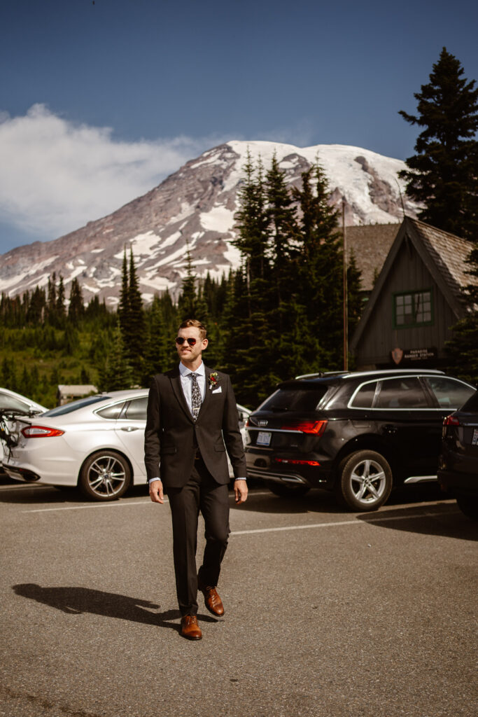 a groom gets ready in the parking lot for a mt rainier micro wedding