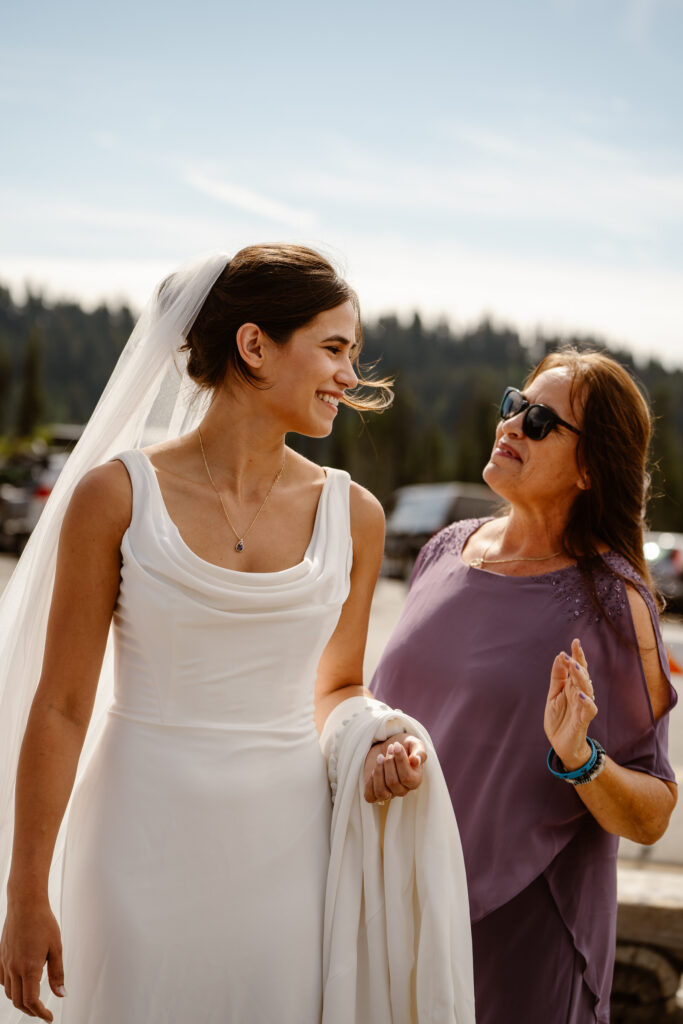 a mother helps her daughter, the bride, get ready for a mt rainier micro wedding