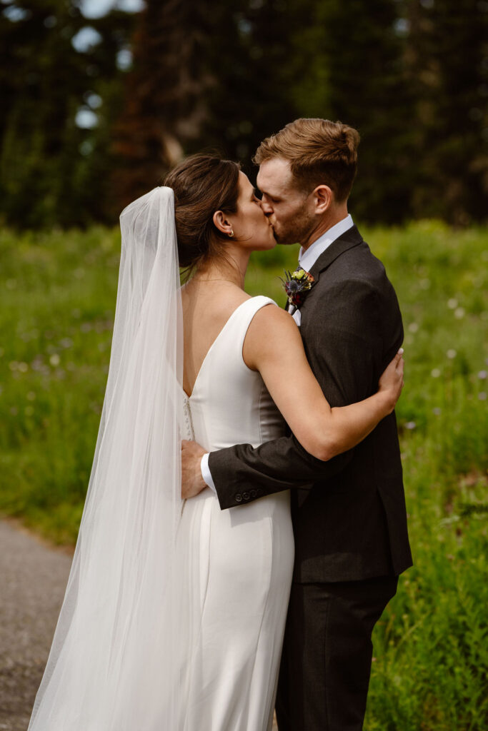 a bride and groom share a first kiss during their mt rainier elopement ceremony