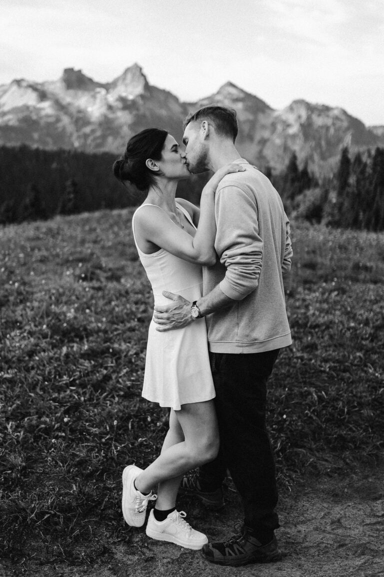 a couple embraces with the tatoosh range in the background