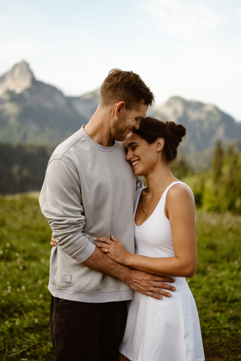 a couple embraces in the meadows of paradise mt rainier