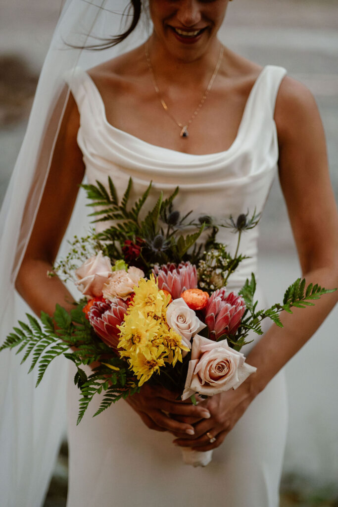 close-up of a bride holding flowers during her mount rainier micro wedding